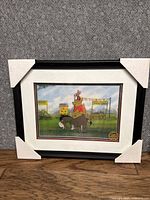 Image of the front of the framed serigraph showing Winnie the Pooh characters and the framing protection corners.