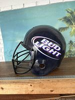 Side view of the large Bud Light football helmet display showing logo and faceguard.