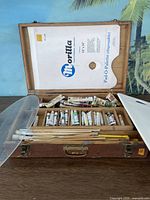 Closed wooden artist suitcase showing overall condition