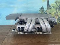 Front view of the tuned port injection intake manifold showing intake runners and injector ports.