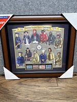 Full view of framed United States Navy Uniforms display including USPS stamps showing overall condition and frame packaging corners.