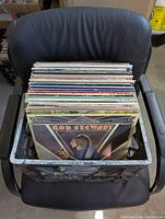Photo of vinyl records in black crate showcasing Rod Stewart Classic Edition album at the front