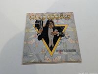 Front cover of Alice Cooper LP Welcome to My Nightmare showing illustrated design with Alice Cooper and insects background.
