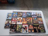 Table with 20 assorted DVD movies arranged in rows showing front covers.