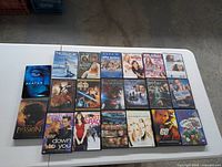 Top-down photo of 23 assorted DVD movies, showing front covers and titles.