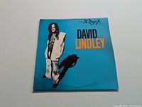 Front cover of David Lindley El Rayo-X LP record sleeve in blue with image of artist.
