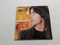Front cover of Jackson Browne Hold Out LP vinyl record, showing Jackson Browne profile picture and album title.