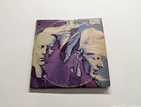 Front cover of the Second Winter Johnny Winter vinyl LP showing multiple images of Johnny Winter with flowing blond hair against a purple background.