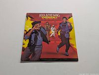 Front cover of Kool & The Gang Emergency LP showing band members against a red and yellow background.