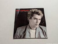 Front cover of the Nik Kershaw Human Racing LP showing musician portrait and title text.