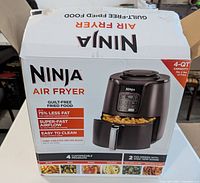 Box of Ninja air fryer showing branding, features, and 4-quart capacity