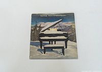 Front cover of vinyl LP with grand piano in snowy mountain setting