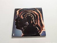 Front cover of the album showing layered silhouette of band members.