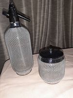 Photo showing the full soda siphon and ice bucket with metal mesh covers and chrome details.