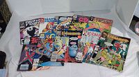 Lot of 10 Marvel comics laid out on white surface showing covers with characters and titles