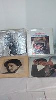 Four Bob Dylan vinyl albums laid out, showing cover art including Bringing It All Back Home and two portrait images of Dylan