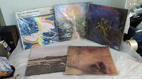 Five Moody Blues vinyl albums displayed on a surface with some wear visible on covers.