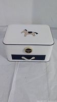 Closed white jewelry box with navy blue edges and horse applique on lid