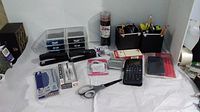 Overview photo showing all items including organizers, pens, pencils, staplers, scissors and calculators