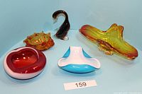 Five art glass pieces with red and white bowl, blue and white bowl, amber yellow-orange bowl, glass duck figurine, and another smaller amber bowl