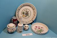 Full view of all pieces in the Portmeirion botanical collection including plate, jars, vinegar jar, and dish.