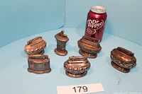 Group photo of all six metal Ronson lighters with Dr Pepper can for size comparison.