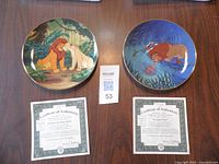 Two Bradford Exchange "The Circle of Life" series collectible plates with Certificates of Authenticity shown alongside on a table.