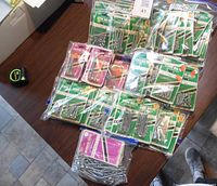 Overview of all packs of stove bolts and carriage bolts arranged on a table showing quantity and packaging.