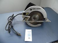Front view of Black & Decker 7 1/4 inch circular saw with visible 21-tooth blade, black motor housing, and cord.