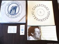 Photo showing boxes and paperwork for MS Veendam inaugural plate and Royal Doulton Collector's International plate.