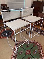 Pair of white bar height chairs side by side