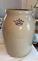 Full view of the beige stoneware crock showing shape and handles with blue crown 3 mark on front.