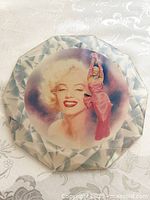 Top view of Marilyn Monroe porcelain wall plaque showing detailed faceted edge and central double image of Monroe.