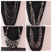 Four different vintage black metal necklaces displayed on velvet busts, showing layered chains, chunky chains, bead styles, and statement pieces