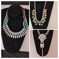 Three vintage silver-tone necklaces displayed on black bust. Left: necklace featuring turquoise beads and silver bars. Top right: silver-tone necklace with green beads on two chains. Bottom right: rhinestone floral necklace with chain tassels.