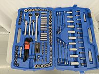 Full view of open blue tool case displaying the complete assortment of ratchets, socket wrenches, hex keys, screwdrivers, and accessories arranged in molded slots.