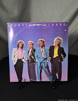 Front cover of Platinum Blonde "Alien Shores" vinyl record album showing four band members standing in front of a purple gradient background.