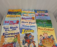 Photo showing a large spread of Robert Munsch children's books with colorful covers, titles clearly visible.