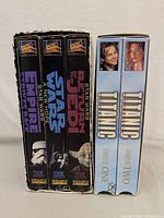 Front view of the VHS box spines showing Star Wars trilogy and Titanic volumes