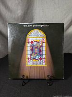 Front cover of vinyl album 'The Turn of a Friendly Card' by The Alan Parsons Project, showing stained glass King of Diamonds card artwork.