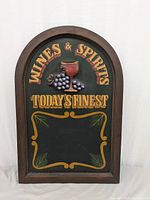 Full front view of the Wines & Spirits chalk board with wooden frame and 3D grapes and glass decoration