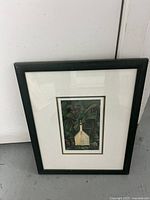 Framed Emily Carr art print with house and lush green background
