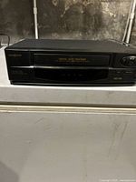 Front view of Broksonic VHS player showing digital auto tracking panel, tape slot, and control buttons.