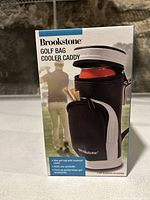 Front view of the Brookstone Golf Bag Cooler Caddy packaging showing product image and features.