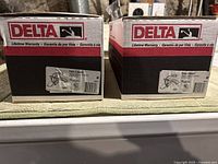 Two boxed Delta bathroom faucets side by side with labels visible showing model 544-CWLF.