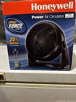 Front view of the Honeywell TurboForce Power air circulator fan box showing product image, brand, and features including 25% quieter operation and eco-friendly design.
