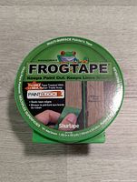 Top view of the FrogTape roll showing label with frog image and product benefits.