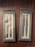 Front view of two unopened packages each containing 2 Merangue fine writing pens