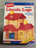 Box front showing image and branding for Playskool Lincoln Logs House Set