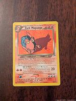 Front of Dark Magcargo Pokémon card showing artwork, health points, power description, and attack details.